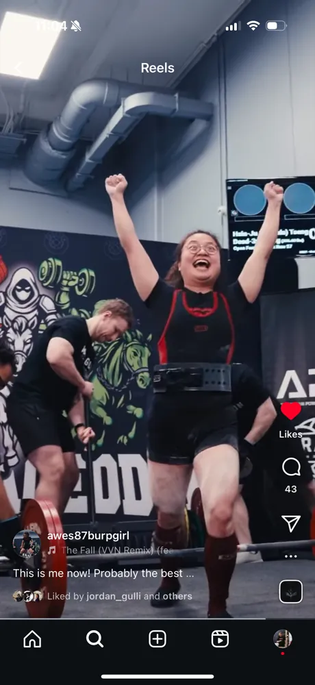 An Underdogs SC lifter celebrating a successful lift with arms raised