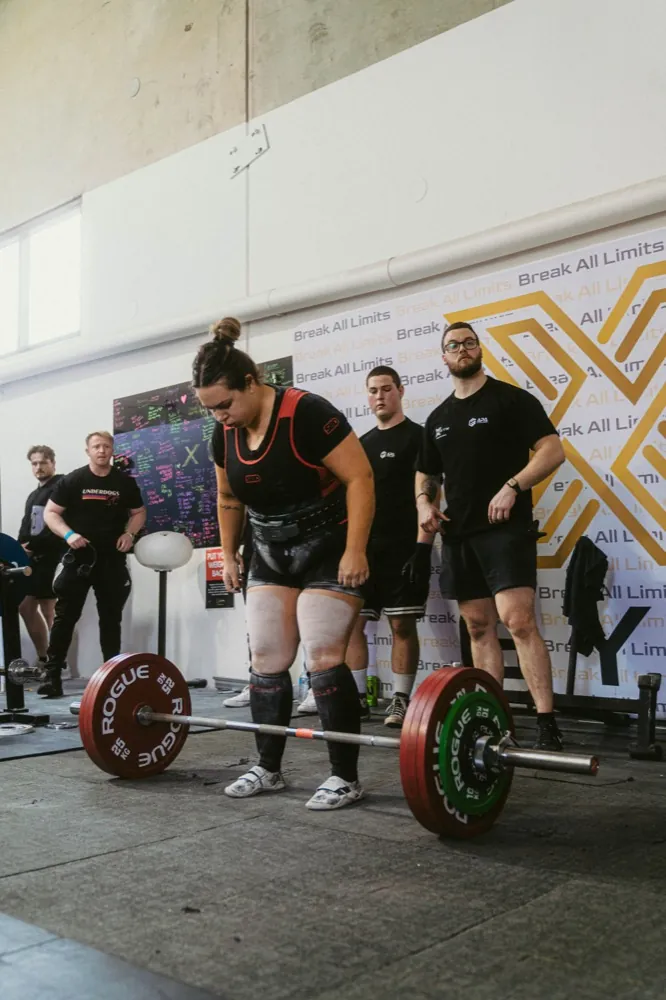 Two lifters shaking hands and congratulating each other at a meet